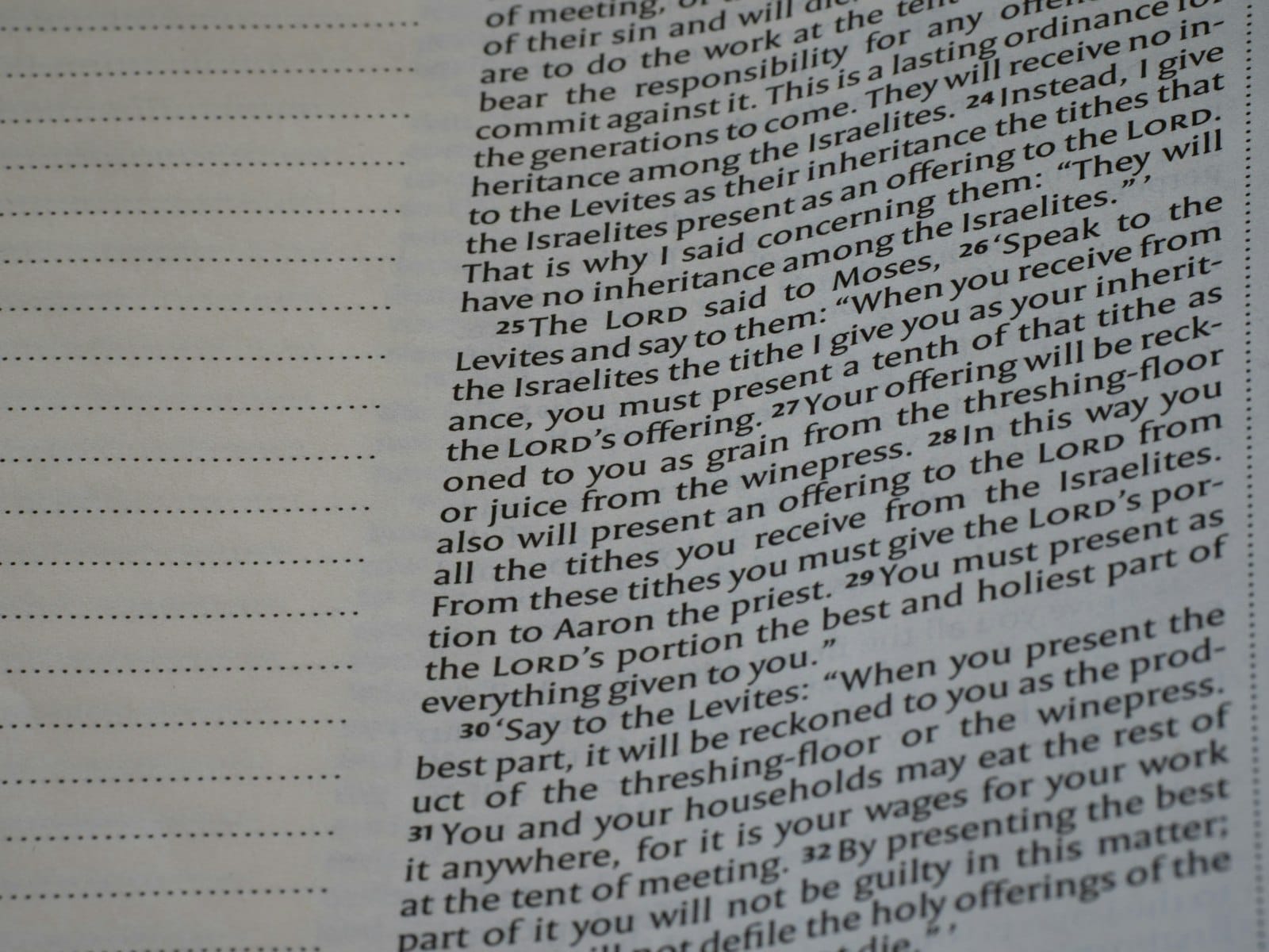 Book page showing printed text and blank ruled lines