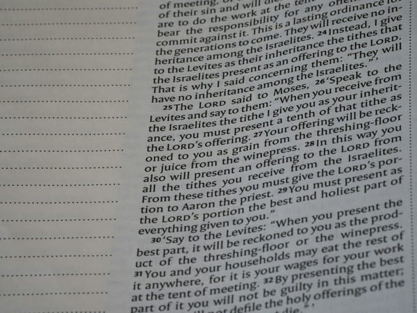 Book page showing printed text and blank ruled lines